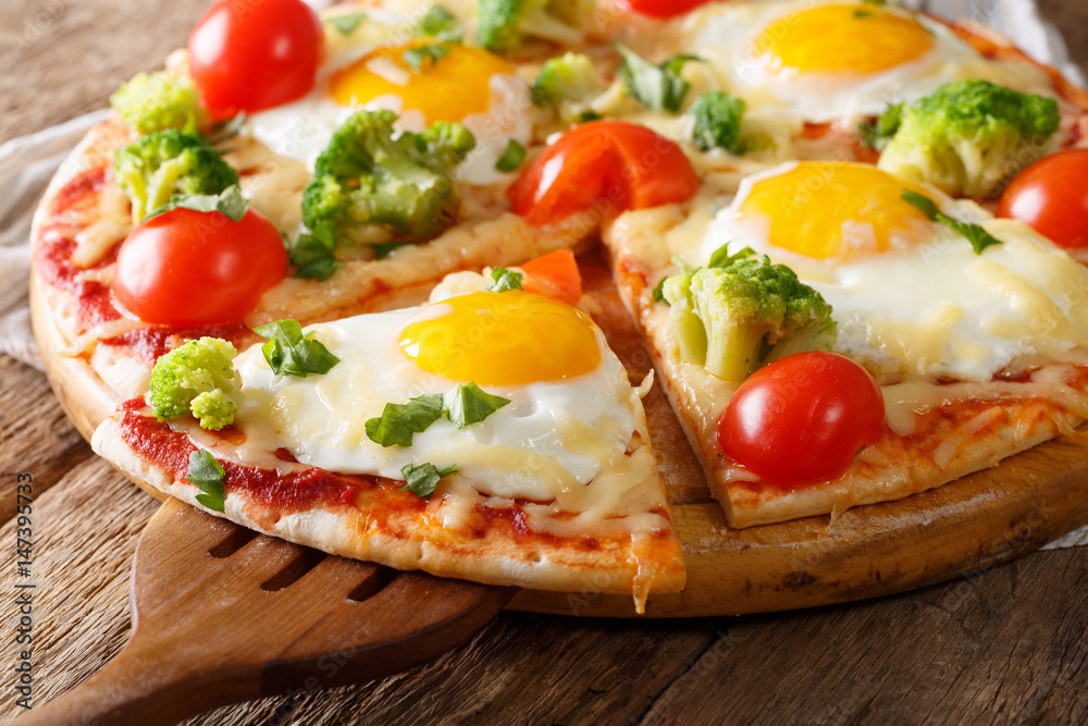Sliced pizza with eggs, broccoli, tomatoes and parsley close-up. horizontal Sliced pizza with eggs, broccoli, tomatoes and parsley close-up. horizontal