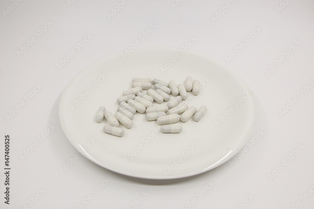 Capsule on white dish Capsule on white dish