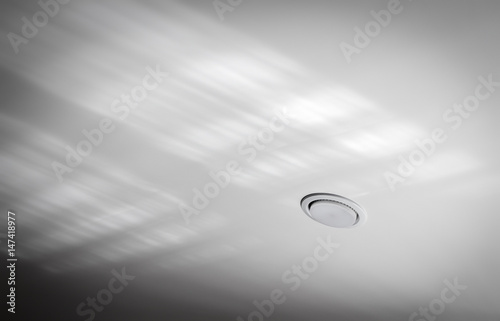 Ceiling recessed lamp close-up on a background of tension ceiling. © sv_production