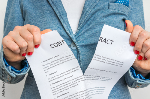 Business woman tearing contract