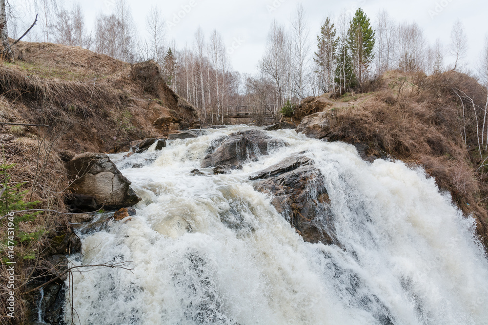 Mountain waterfall. Water flows from the rock. Mountain waterfall. Water flows from the rock.