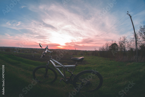 Bicycle on sunset background.