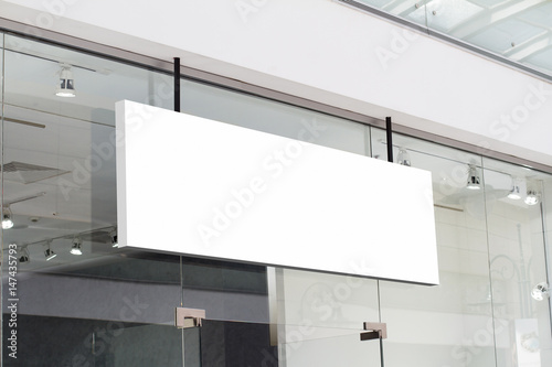 horizontal white signage on shop front photo