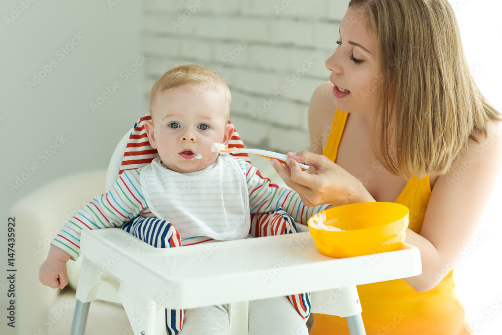 A woman is feeding a child A woman is feeding a child