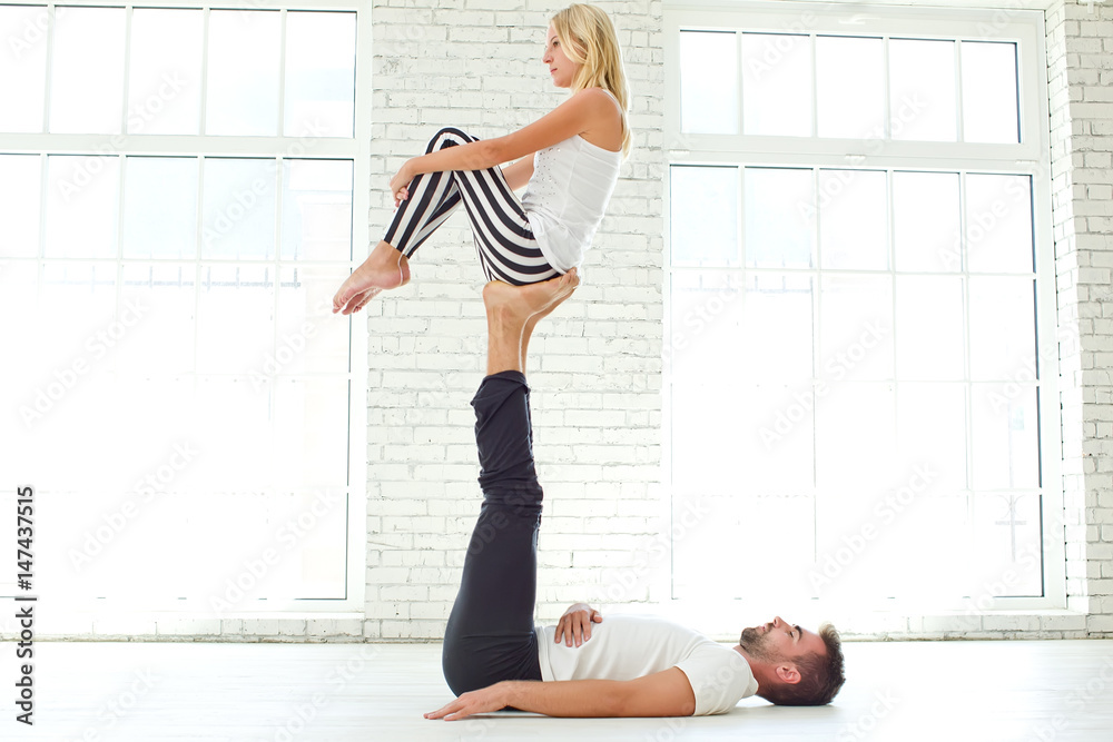 Fototapeta premium Man and woman doing yoga