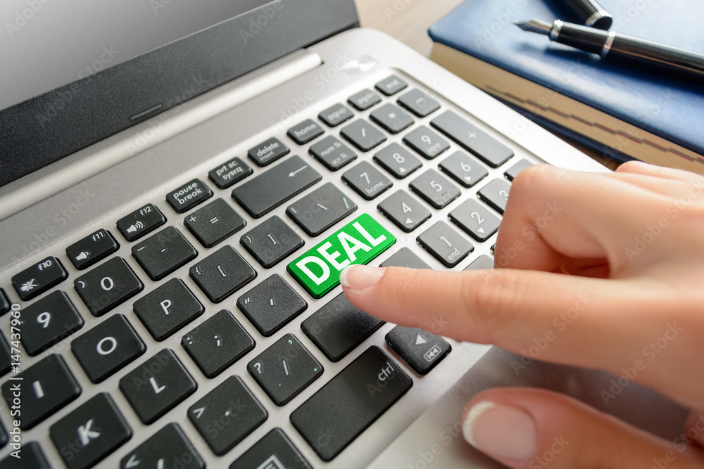 Closed up finger on keyboard with text Deal Closed up finger on keyboard with text Deal
