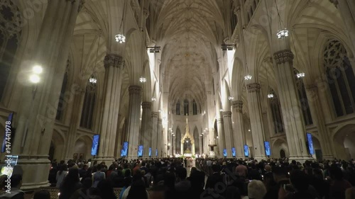 New York, USA St. Patricks Cathedral with people during mass.
Inside The Cathedral of St. Patrick, a Neo-Gothic Roman Catholic church between 50th and 51st Streets Manhattan.
 photo
