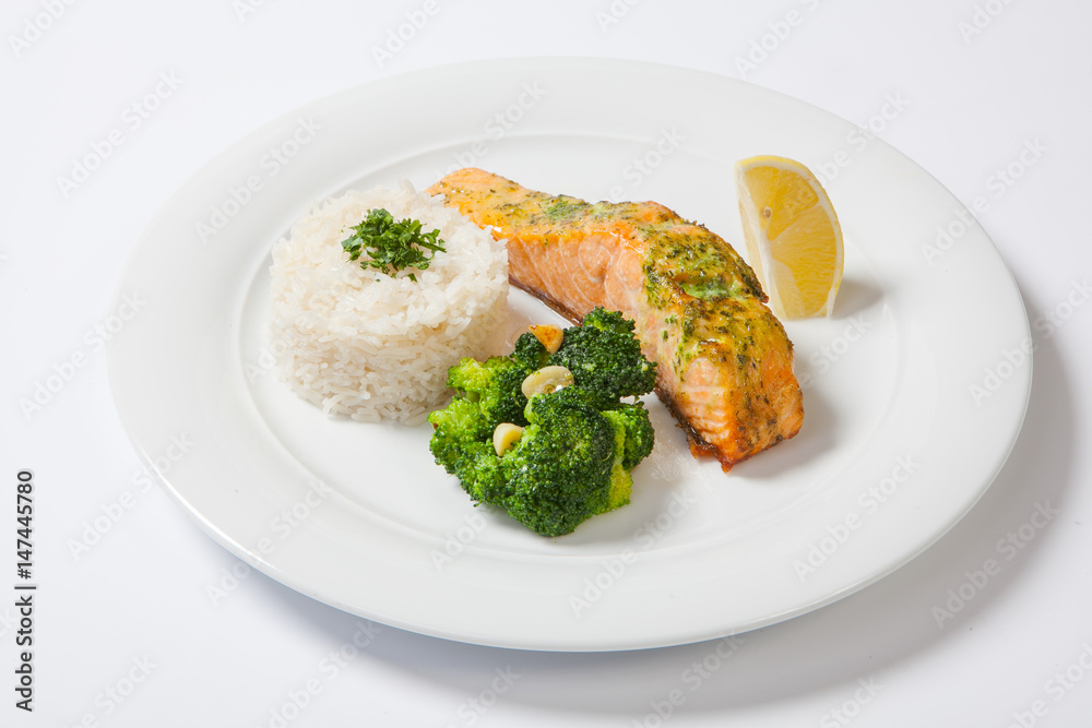 Salmon stake with boiled rise on a white background