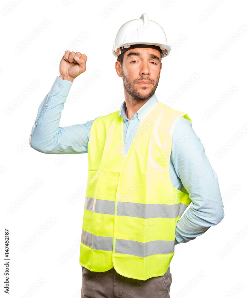 Successful engineer with his fist up against white background
