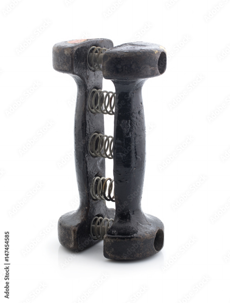 Old black dumbbell with springs on white background Old black dumbbell with springs on white background