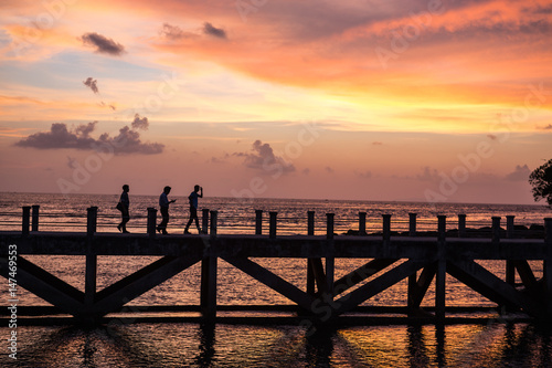 siluate picture 3 man walking on the bridge when sunset time