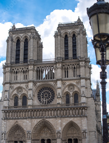 Ornate lantern stands before Notre Dame in Paris