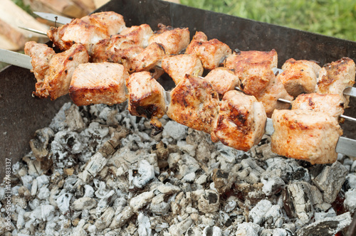 juicy fried meat on skewers outdoors