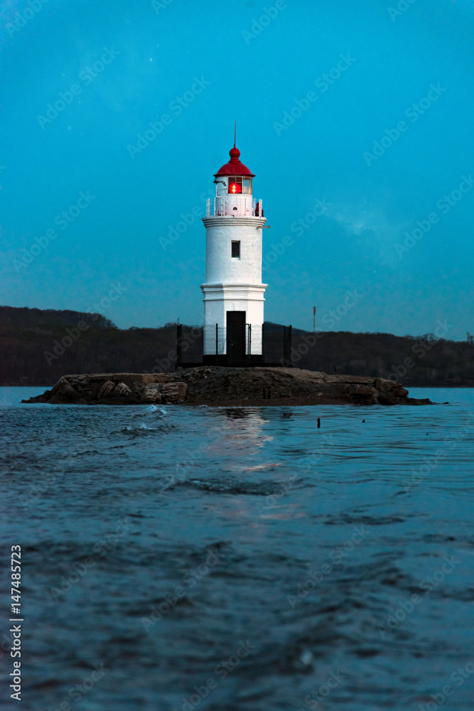 Lighthouse at sea at dusk