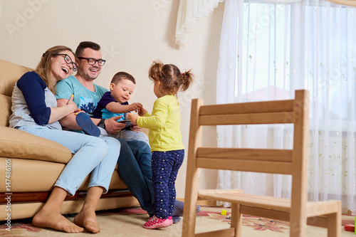 Parents and children happy laugh in the room of their house. © Studio Romantic
