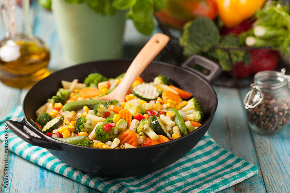 Mix of vegetables fried in a wok.