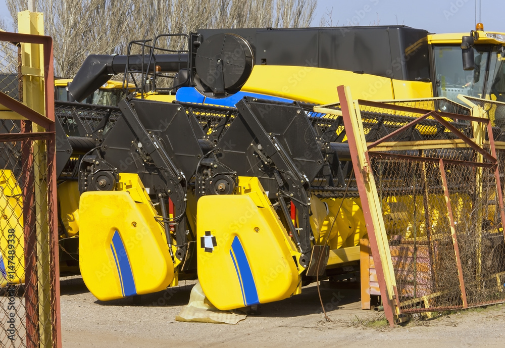 Harvesters and harvester parts at the plant are waiting for assembly, tractors and agricultural machinery