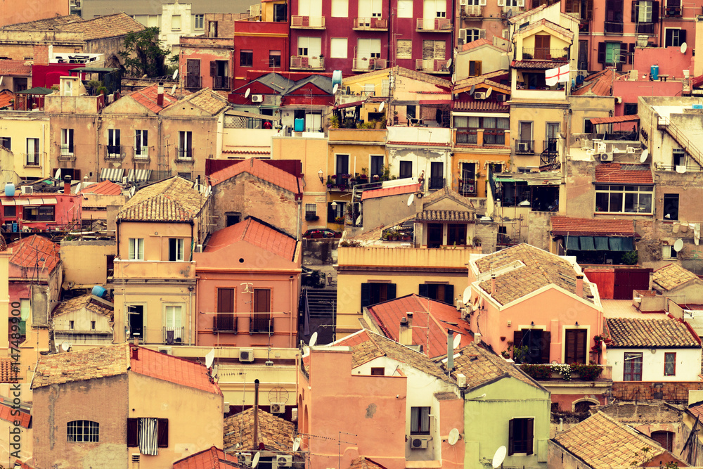 Small coloured houses pattern in the poor neighborhood. Europa, Italy, Sardinia. Horizontal. Toning.