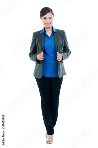 Full length portrait of a young businesswoman over white background