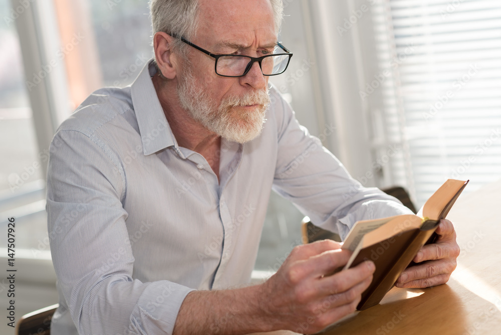 Mature man reading a book Mature man reading a book