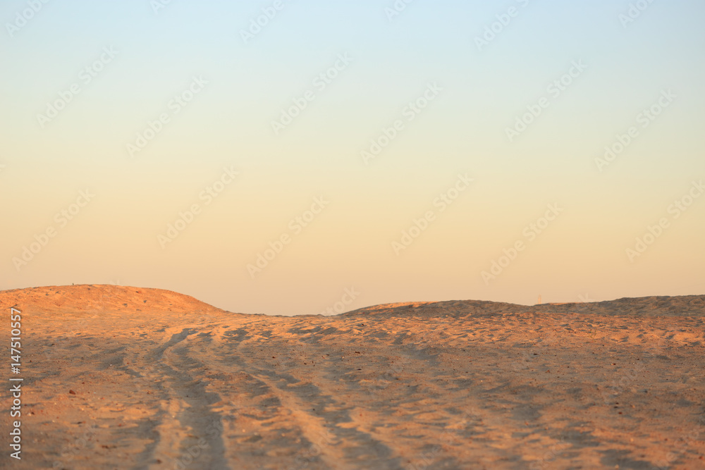 Golden desert sand at sunset. Gradient on the horizon