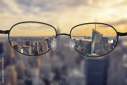 Clear cityscape focused in glasses lenses photo