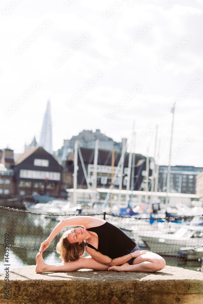 Woman in Yoga position in harbour