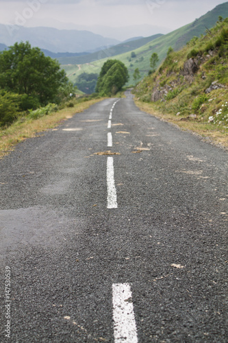 empty straight road in beautiful green iraty   irati hills  basque country  france