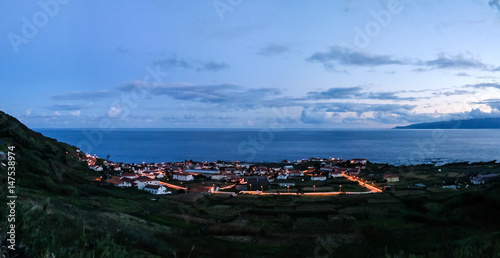 Aerial view to Vila do Corvo and Flores island at sunset in Corvo island, Azores, Portugal © homocosmicos