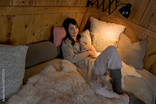 Young woman relaxing in bed photo