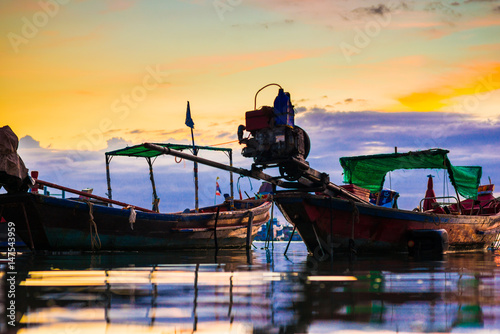 Wooden fishery boat on sand beach sunset