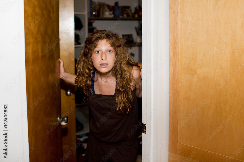 Teenage girl opening door Teenage girl opening door