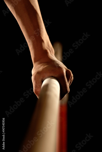 gymnast's hand grabbing bar