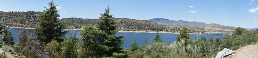 The El Burguillo Reservoir panoramic view. It is located along the Alberche river in the province of Ávila, Spain, between the municipalities of El Tiemblo and El Barraco.