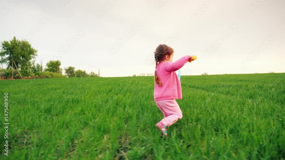 Two little girls running along the green field, playing with soap bubbles. Concept - a happy childhood. Steadicam slow motion shot Two little girls running along the green field, playing with soap bubbles. Concept - a happy childhood. Steadicam slow motion shot