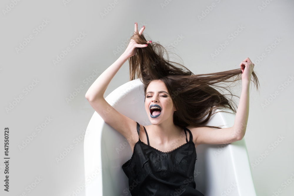 Naklejka premium woman in dress with long hair, black lipstick in bath