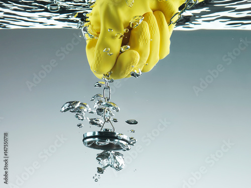 Rubber glove pulling plug in water