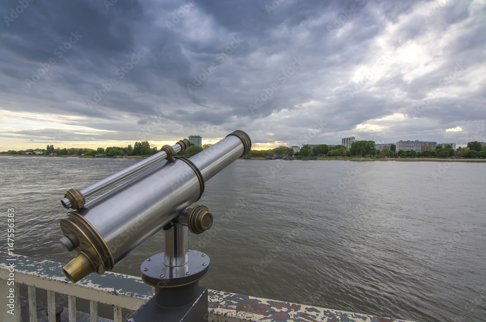 View of the Shelda River from the viewing platform of the wharf of Antwerp. Telescope with landscape View of the Shelda River from the viewing platform of the wharf of Antwerp. Telescope with landscape