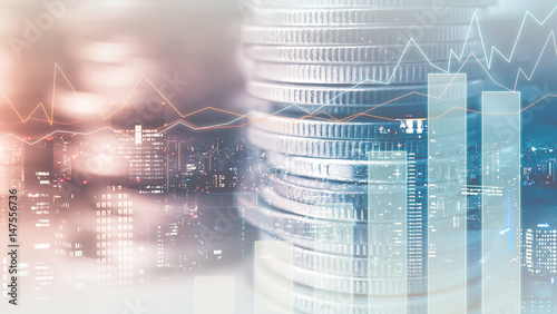 Double exposure of city and rows of coins for finance and banking concept