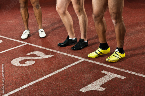 Athletes preparing to race on sportstrack, low section photo