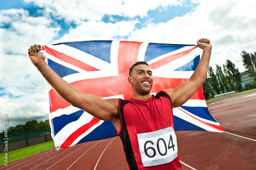 Sprinter holding Union flag on sportstrack photo