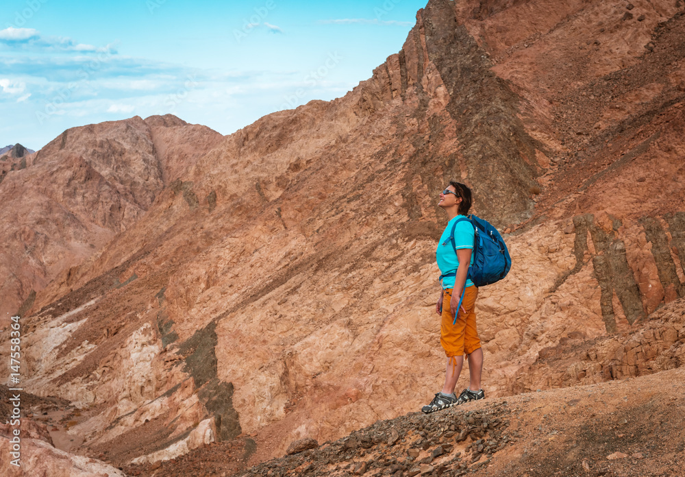 Woman Hiker with backpack enjoy view in desert Woman Hiker with backpack enjoy view in desert