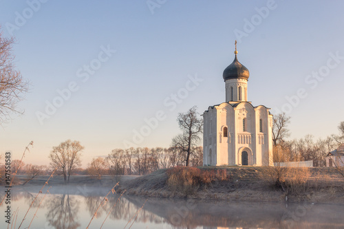 View to the Church of the Intercession of the Holy Virgin on the Nerl River in sunlight. photo