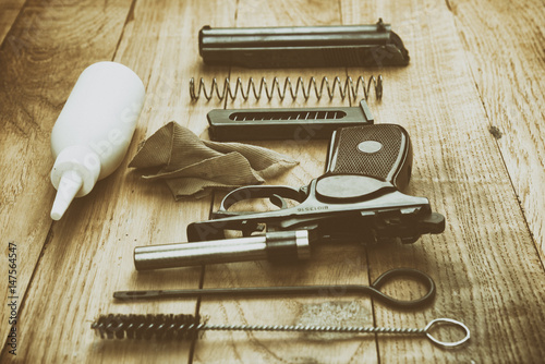 Separate parts of pistol and cleaning kit photo