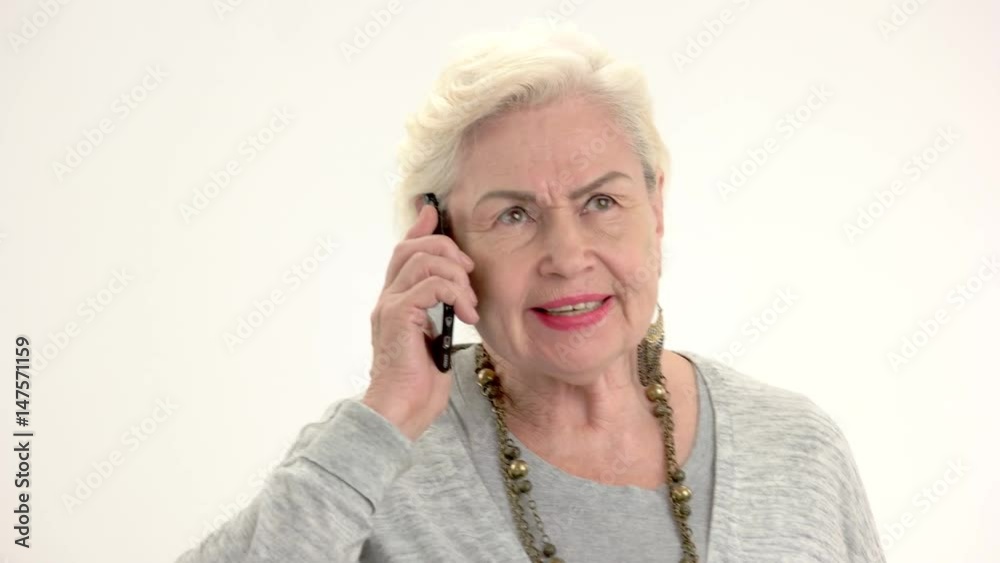 Old lady talking on phone. Elderly woman isolated. Best prices for international calls. Old lady talking on phone. Elderly woman isolated. Best prices for international calls.