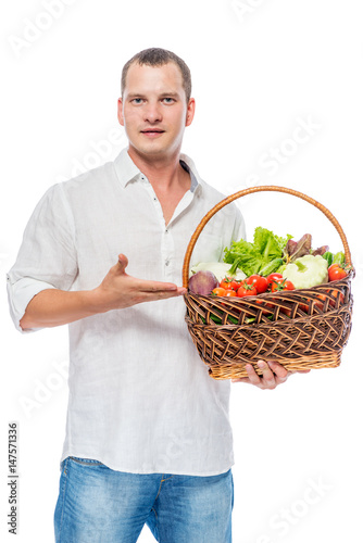 Farmer presents organic vegetables in a basket on a white background