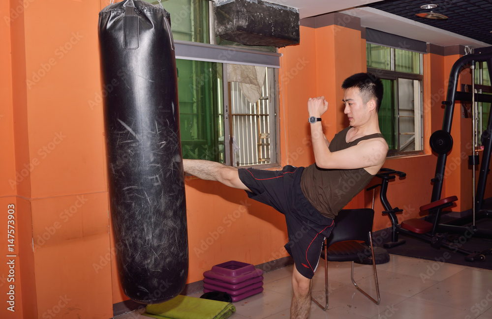 Young  kickboxer training at gym