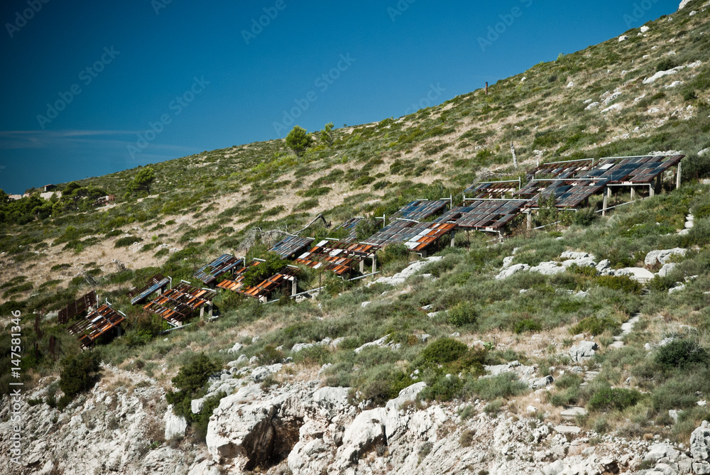 Abandoned dirty demolished building, one of hotels in Kupari complex near Dubrovnik city, old solar panels