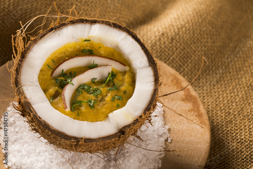 Sururu soup inside a coconut. Brazilian dish.