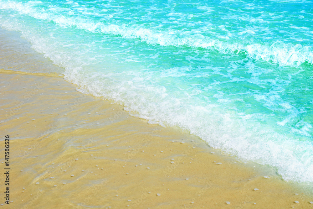 Soft wave of blue ocean on sandy beach